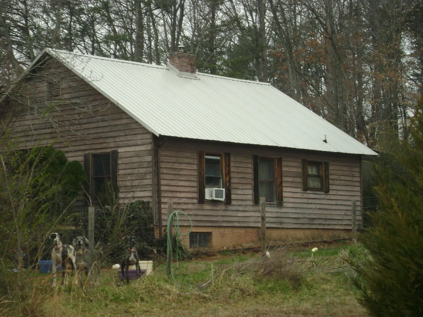 White metal roof on an old wood sided farmhouse, from a Metal Roof Installation job in Nickelsville